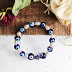 Load image into Gallery viewer, Evil Eye Pearl Hamsa Hand Bracelet
